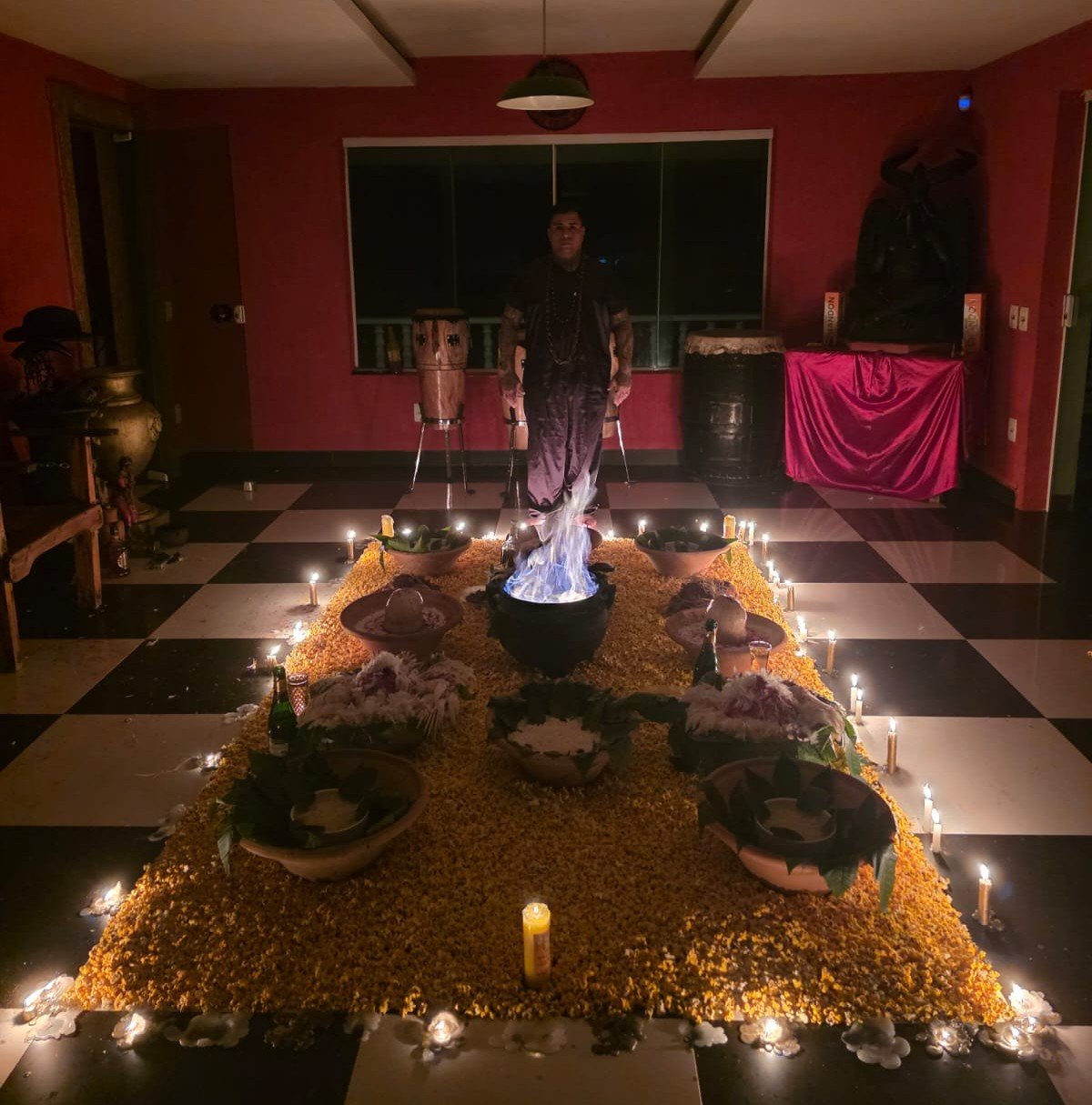 Ritual espiritual com velas, oferendas e preparação no terreiro
